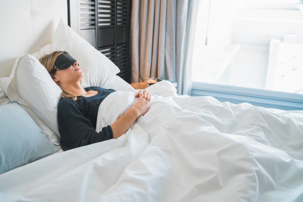 Woman sleeping with sleep mask.